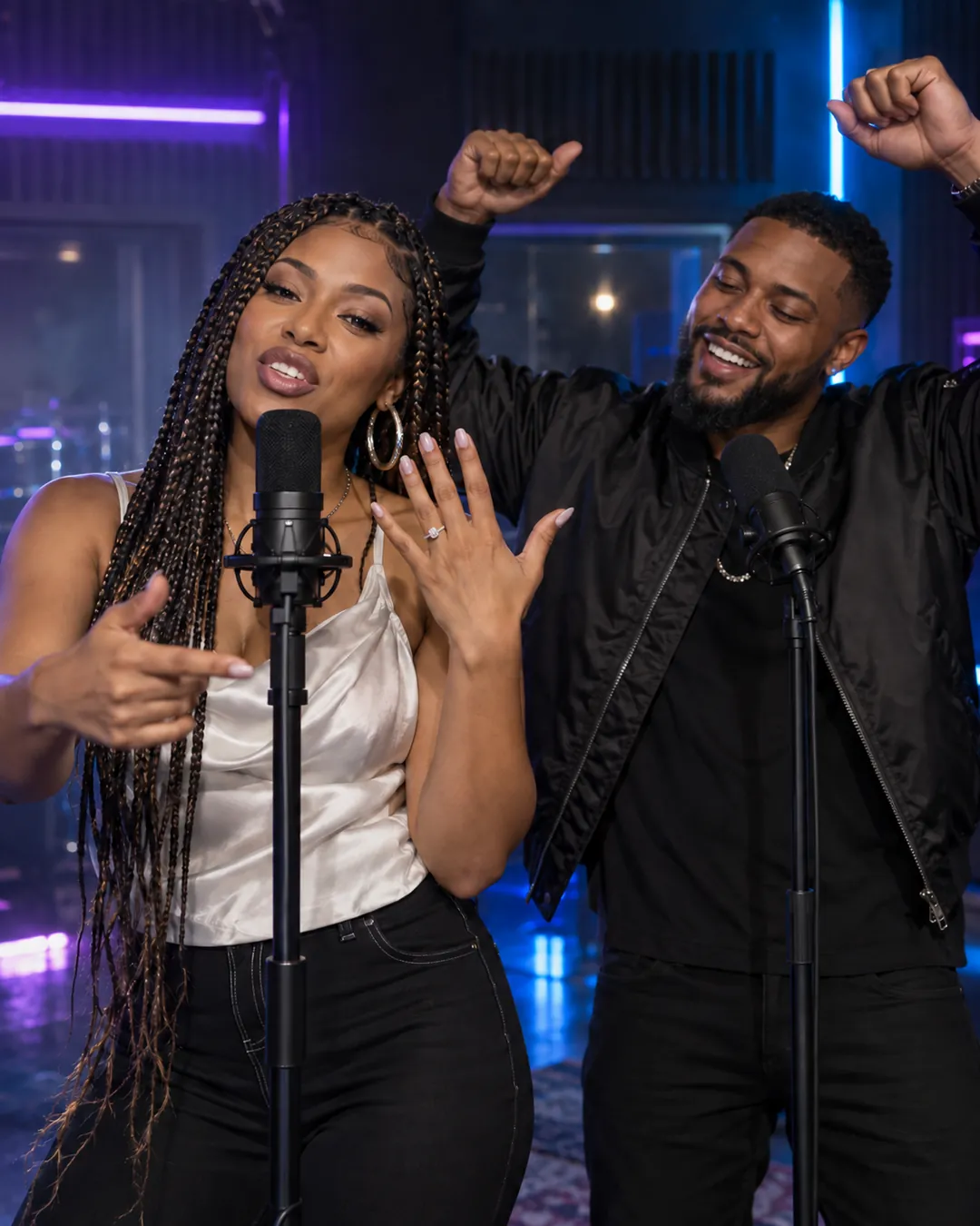 Engaged couple celebrating with a rap and an engagement ring in a neon recording studio